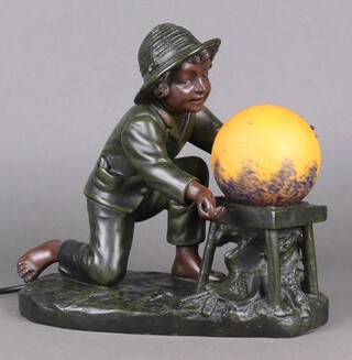 After A de Ranei, a bronzed table lamp in the form of a boy kneeling by a sphere 28cm h x 31cm w