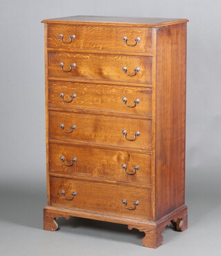 An oak chest of 6 long drawers with swan neck drop handles, raised on bracket feet 137cm h x 81cm w x 46cm d 