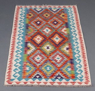 A yellow, turquoise and green ground Chobi Kilim rug with overall geometric design 126cm x 80cm 