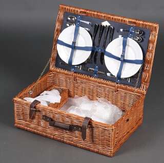 A wicker picnic hamper by Amberley 19cm x 58cm x 37cm, containing plates, knives and forks 