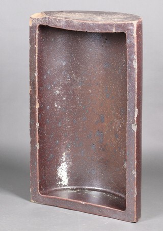A crescent shaped "copper" glazed cattle feed 26cm x 53cm x 86cm 