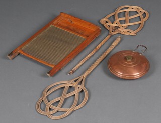 A circular copper and brass foot warmer, a wash board and 2 wicker carpet beaters 