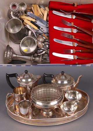 A silver plated 4 piece tea service with tea pot, hot water jug, milk jug and sugar bowl, 2 silver plated tankards, ditto rose bowl, a twin handled tray, a pair of silver plated candlesticks, 2 pewter tankards and a quantity of silver plated flatware 