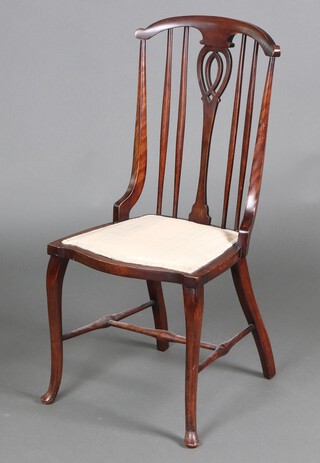 An Edwardian stick and rail back bedroom chair with upholstered seat, raised on cabriole supports with H framed stretcher 