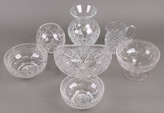 A cut glass vase 21cm, 1 other cut glass vase, 3 cut glass bowls, a boat shaped bowl and a jug 