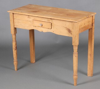 A Victorian rectangular pine side table fitted a frieze drawer, raised on turned supports 72cm h x 90cm w x 41cm d (split to top) 