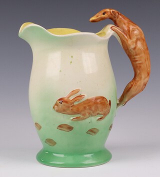 An Art Deco Samford Ware 18th Century style pottery jug, the body decorated a running hare, the handle in the form of a greyhound 18cm (crazing, star crack to base)