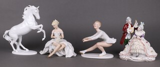 A collection of German porcelain figures - ice skater 18cm, seated lady with fan 19cm, lady and gentleman 21cm and a rearing horse 27cm  
