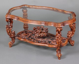 An Italian style resin coffee table of serpentine outline with plate glass top, the pierced base with basket of roses, raised on cabriole supports 47cm h x 94cm w x 56cm d 