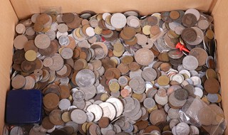 A large collection of world coinage, contained in a cardboard box