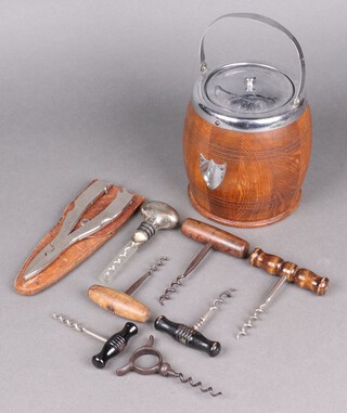 A 1930's oak biscuit barrel, a Fisherman's friend in leather carrying case and 7 carious corkscrews 