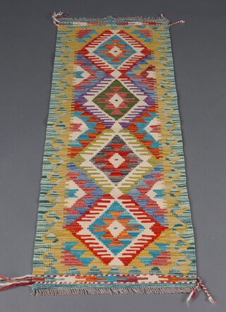 A yellow and green ground Chobi Kilim runner with 4 diamonds to the centre 156cm x 53cm 