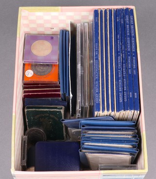 A collection of GB coin sets and commemorative crowns 