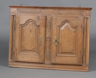 An 18th Century Continental carved oak "serving hatch" formed from a section of carved panelling 60cm h 81cm