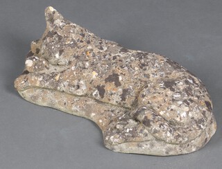 A well weathered concrete garden  figure of a sleeping cat 