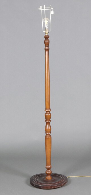 A turned beech standard lamp on a circular base 136cm 