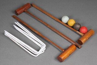 A croquet set comprising 3 mallets, 4 balls and 6 hoops