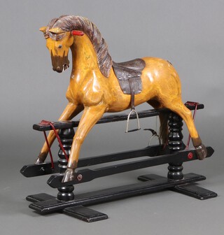 A carved wooden rocking horse with ebonised base 79cm h 