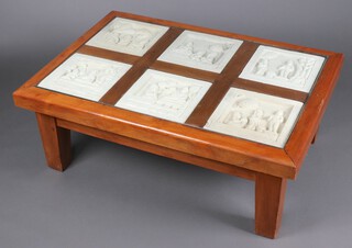 A 20th Century Eastern hardwood rectangular coffee table, inset with 6 carved stone plaques decorated deities, 43cm h x 119cm w x 82cm d 
