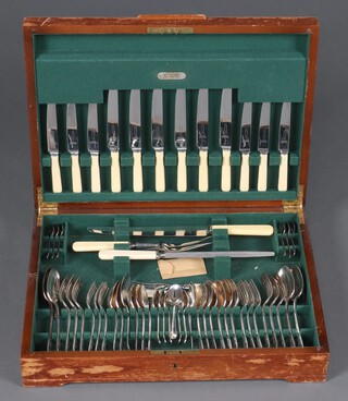 A 55 piece canteen of Old English rat tail pattern flatware comprising 3 piece carving set, 6 soup spoons, 5 serving spoons, 6 dinner knives, 6 dinner forks, 6 pudding spoons, 6 pudding forks, 6 tea spoons, 6 coffee spoons and an associated fish knife and fork, all contained in a walnut canteen (box has water marks) 