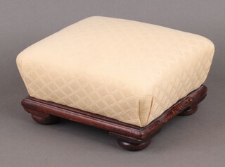 A square footstool upholstered in yellow material on bun feet 12cm h x 24cm w x 27cm d 