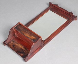 An Edwardian rectangular bevelled plate mirror contained in an oak frame, the base fitted a box with hinged lid 70cm x 36cm