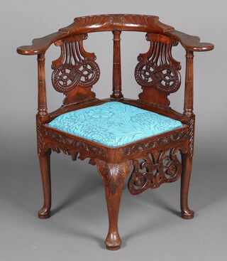 A Georgian carved and pierced mahogany slat back corner chair with turned and reeded columns to the back, raised on club supports 81cm h x 80cm w x 58cm d 