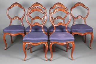 A set of 6 Victorian Continental carved mahogany balloon back dining chairs with over stuffed seats, the cresting rails carved roses, raised on cabriole supports 95cm h x 46cm w x 43cm d 