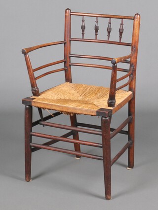 William Morris, an elm spindle back Sussex armchair with woven rush seat 84cm h x 49cm w x 41cm d  