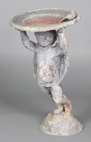 A 19th Century cast lead bird bath in the form of a cherub supporting a dish with seated dove 68cm h x 37cm diam. 
