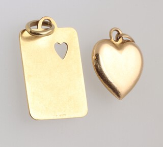 A yellow gold, testing as 18ct playing card charm, together with an 18ct heart shaped pendant 3.8 grams 