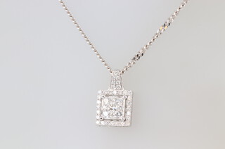 An 18ct white gold diamond set square pendant, the reverse marked 0.832ct, hung on a fine 18ct white gold chain, 9.5 grams 