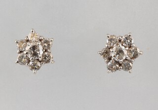 A pair of diamond cluster earrings, each set 7 diamonds