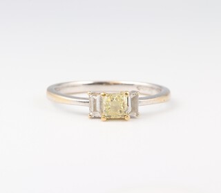 A lady's 18ct white gold 3 stone engagement ring set a princess cut yellow diamond (approx 0.45ct, clarity VS) set in yellow gold mount surmounted by 2 baguette cut diamonds (0.17ct total, colour g, clarity VS), size N       