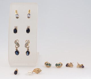A pair of 9ct yellow gold sapphire set ear studs, 4 other pairs of gem set earrings and 2 odd earrings, 10.9 grams gross