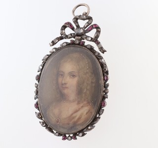 An early 19th Century silver pendant, set diamond chips and rubies and having a watercolour portrait miniature of a lady to the centre 