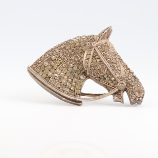 A 925 Continental silver horse shaped brooch set paste stones, together with a bow shaped brooch 