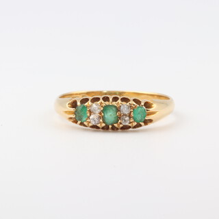 An 18ct yellow gold emerald and diamond set ring, size P 1/2, 2.8 grams