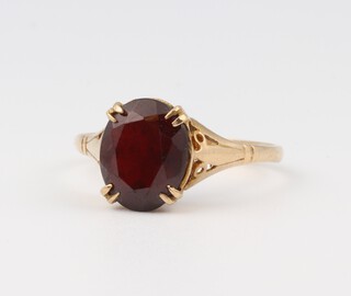 A 9ct yellow gold garnet set ring, size O 1/2, 2 grams