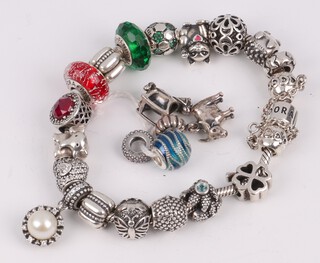 A Pandora charm bracelet with a quantity of various charms, together with 4 loose charms 
