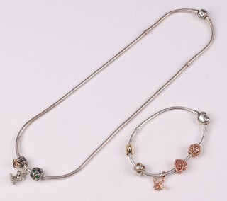 A Pandora silver necklace hung 3 charms together with an ensuite bracelet with 3 charms 
