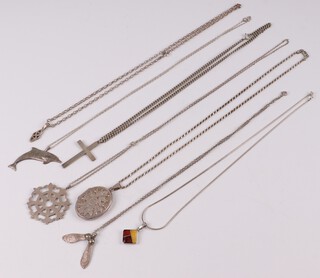 An engraved oval silver locket pendant hung on a silver chain, a pierced silver pendant on chain, an engine turned silver cross on chain, a Celtic charm on a silver belcher link chain, a pendant in the form of a sycamore seed and  a silver enamelled pendant on chain 90 grams gross