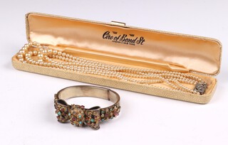 A white metal bracelet set gem stones, marked AR together with a string of simulated pearls 