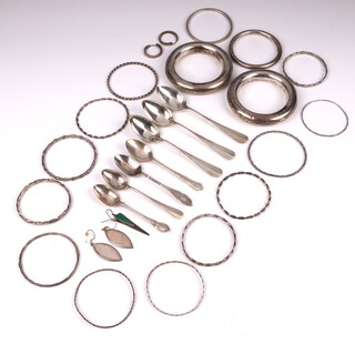16 white metal bangles and 2 silver teaspoons, together with 5 silver plated teaspoons 