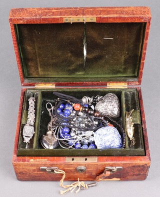 A cocktail wristwatch contained in a silver and marcasite case, a silver heart shaped flask pendant hung on a chain and a small collection of costume jewellery contained in a C J Vickery leather case  