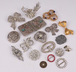 A Hollywood gilt metal bow brooch, a German Crosse brooch dated 1967 and a collection of diamonte set brooches and a buckle 