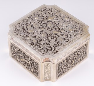 An Eastern pierced and engraved white metal box with hinged lid decorated birds amongst branches 7cm x 14cm x 14cm, 427 grams 