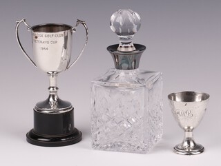 A silver egg cup Sheffield 1926 by Walker & Hall, together with a silver twin handled trophy cup London 1962, 115 grams and a cut glass dressing table bottle with silver collar 