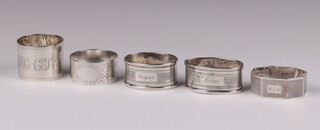 An engraved silver napkin ring Sheffield 1910, a floral engraved ditto Birmingham 1900, an octagonal ditto Birmingham 1932 and a pair of engraved ditto Birmingham 1959 (dented), 117 grams 