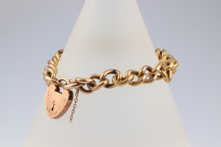 A 9ct yellow hollow gold curb link bracelet with heart shaped padlock, 10.5 grams